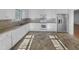 Bright kitchen featuring white cabinets, stainless steel refrigerator, and ample counter space for cooking at 48 Delmar Ct, Fuquay Varina, NC 27526