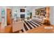Bright living room with fireplace, stylish furniture, decor, and beautiful hardwood floors at 48 Delmar Ct, Fuquay Varina, NC 27526