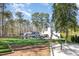 Expansive backyard with covered patio, outdoor kitchen, bocce court, and playground slide at 509 Queensferry Rd, Cary, NC 27511