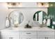 Bathroom featuring double sinks, gold fixtures, ample counter space, and stylish mirrors at 509 Queensferry Rd, Cary, NC 27511