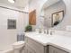 Updated bathroom featuring a modern vanity, round mirror, and tiled walk-in shower at 509 Queensferry Rd, Cary, NC 27511