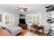 Comfortable bedroom with wood floors, ceiling fan, shutters, and a desk area at 509 Queensferry Rd, Cary, NC 27511