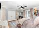 Spacious bedroom with hardwood floors, ceiling fan, and cozy pink seating area at 509 Queensferry Rd, Cary, NC 27511
