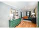 Bright bedroom featuring wood floors, stylish dresser, and views into another room at 509 Queensferry Rd, Cary, NC 27511