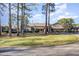 Well maintained clubhouse with green lawn and mature trees, showcasing community's landscaping at 509 Queensferry Rd, Cary, NC 27511