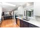 Well-lit kitchen with stainless steel appliances, white countertops, modern fixtures and an attached bar and dining area at 509 Queensferry Rd, Cary, NC 27511