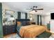 Well-decorated main bedroom offers wallpapered accent wall, plush bedding, dark dresser, and lots of natural light at 509 Queensferry Rd, Cary, NC 27511