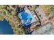 Aerial view of a community pool featuring lap lanes, a wading pool, and a parking area with mature trees at 509 Queensferry Rd, Cary, NC 27511