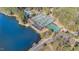 Aerial view of community tennis courts next to a lake, offering a picturesque recreational space at 509 Queensferry Rd, Cary, NC 27511