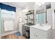 Bright bathroom featuring double vanity, decorative shelving, and updated fixtures and a window at 513 S Cheatham St, Franklinton, NC 27525