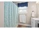 Bright bathroom featuring a shower, window, and towel rack at 513 S Cheatham St, Franklinton, NC 27525