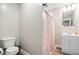 Cozy bathroom featuring a shower with patterned curtain and neutral decor at 513 S Cheatham St, Franklinton, NC 27525