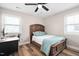 Charming bedroom featuring a queen bed, two windows and a ceiling fan at 513 S Cheatham St, Franklinton, NC 27525