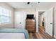 Bedroom featuring a wooden dresser with a TV and a double door closet at 513 S Cheatham St, Franklinton, NC 27525