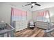 Bedroom featuring a crib, changing table, glider, and natural light at 513 S Cheatham St, Franklinton, NC 27525