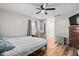 Simple bedroom with hardwood floors, fan and a comfortable bed at 513 S Cheatham St, Franklinton, NC 27525