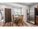 Bright dining area with wooden table set, storage cabinet, and stainless steel refrigerator at 513 S Cheatham St, Franklinton, NC 27525