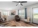 Comfortable living room featuring wood floors, ceiling fan and windows with curtains at 513 S Cheatham St, Franklinton, NC 27525