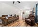 Comfortable living room featuring a sofa, recliner, and open access to the kitchen at 513 S Cheatham St, Franklinton, NC 27525