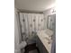 Bathroom featuring a shower with a floral patterned curtain, vanity with sink, and modern fixtures at 529 Flanagan Rd, Henderson, NC 27537