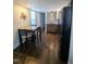 Dining area features hardwood flooring, a table and chairs, and connects to kitchen at 529 Flanagan Rd, Henderson, NC 27537