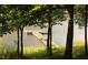 Scenic view of wooden dock on a serene lake surrounded by lush greenery at 529 Flanagan Rd, Henderson, NC 27537
