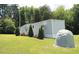 Exterior view of a light gray single-story home featuring neatly arranged landscaping at 529 Flanagan Rd, Henderson, NC 27537