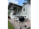 Backyard view with tiki torches, a grill, and a picnic table on a pea gravel patio at 529 Flanagan Rd, Henderson, NC 27537