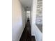 Hallway with wood flooring connects kitchen to the bedroom area at 529 Flanagan Rd, Henderson, NC 27537