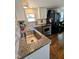 Bright kitchen features stainless appliances, granite counters, tile backsplash and dark hardwood flooring at 529 Flanagan Rd, Henderson, NC 27537