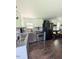 Updated kitchen features stainless steel appliances, modern countertops, and warm-toned wood flooring at 529 Flanagan Rd, Henderson, NC 27537