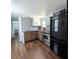 The kitchen features granite counters, stainless appliances, tile backsplash, and wood flooring at 529 Flanagan Rd, Henderson, NC 27537