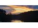 Beautiful scenery featuring the lake reflecting colorful clouds and sky during a tranquil sunset at 529 Flanagan Rd, Henderson, NC 27537