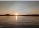 Tranquil scenery of a lake with a stunning sunrise, creating a peaceful and calming waterfront setting at 529 Flanagan Rd, Henderson, NC 27537