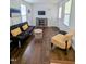 Clean living room with hardwood floors, a comfortable futon, and a TV at 529 Flanagan Rd, Henderson, NC 27537