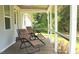 Relaxing porch with two lounge chairs, perfect for enjoying the peaceful outdoor scenery at 529 Flanagan Rd, Henderson, NC 27537