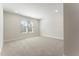 An empty bedroom with carpeted floors, white walls, and natural light from a window at 604 Whistable Ave, Wake Forest, NC 27587