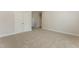 An empty bedroom featuring neutral carpeting, white trim, and a double closet at 604 Whistable Ave, Wake Forest, NC 27587