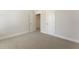 Bedroom featuring neutral carpet, white trim, and an open doorway at 604 Whistable Ave, Wake Forest, NC 27587