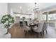 Open concept dining area flowing into a modern kitchen with a center island and additional seating at 604 Whistable Ave, Wake Forest, NC 27587