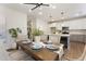 Staged dining room with modern chandelier, table and chairs and open view to the bright white and gray kitchen at 604 Whistable Ave, Wake Forest, NC 27587