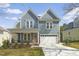 Charming two-story home with light blue siding, a two-car garage and a well-manicured lawn at 604 Whistable Ave, Wake Forest, NC 27587