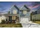 Charming two-story home with light blue siding, a two-car garage and a well-manicured lawn at 604 Whistable Ave, Wake Forest, NC 27587