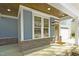 Inviting front porch with brick accents, a stained wood ceiling, and a cozy entrance at 604 Whistable Ave, Wake Forest, NC 27587