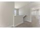 A hallway features neutral carpet and white walls, leading to an open doorway at 604 Whistable Ave, Wake Forest, NC 27587