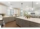 This kitchen offers stone countertops, stainless steel appliances, and a view to an open concept living space at 604 Whistable Ave, Wake Forest, NC 27587