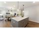 Charming kitchen with stainless appliances, stone countertops, an island with seating, and an adjacent dining area at 604 Whistable Ave, Wake Forest, NC 27587