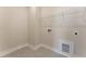 The laundry room has gray hexagonal tiles and a white wire rack for storage at 604 Whistable Ave, Wake Forest, NC 27587