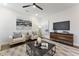Living room with modern art, neutral color scheme, lots of natural light, and hardwood flooring at 604 Whistable Ave, Wake Forest, NC 27587