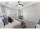Bright main bedroom with a king-sized bed, large windows and ceiling fan, showcasing natural light at 604 Whistable Ave, Wake Forest, NC 27587